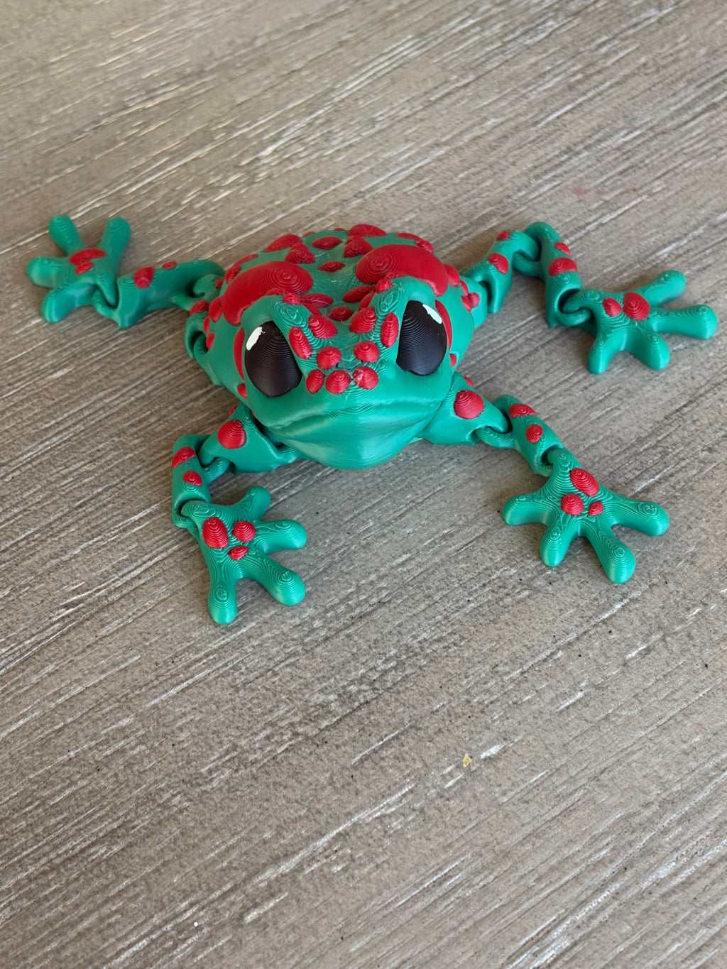 3D Printed Articulated Frog Toy with Green Body and Red Spots for Kids' Play